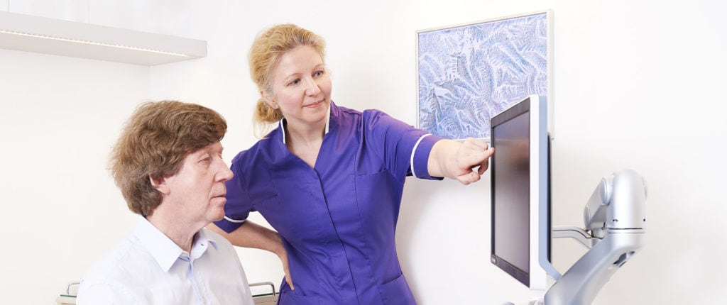 Women’s health consultation with a healthcare professional and patient in a clinical setting.